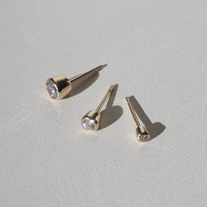 0.20 TCW Round Cut Moissanite Bezel Earrings in Gold 1